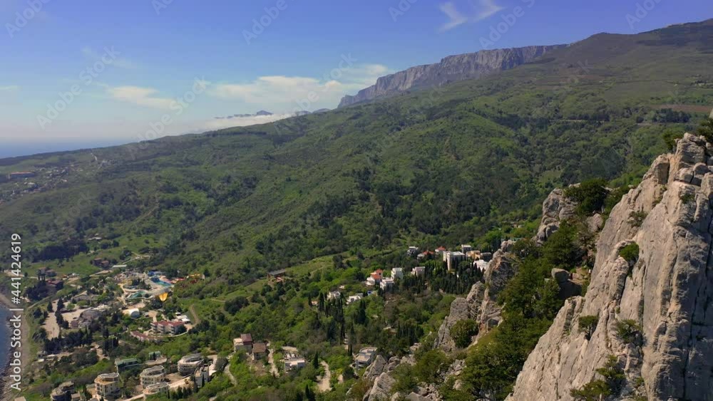 Aerial View of the village of Simeiz, Mount Koshka and Mount Krylo Lebedya (Swan's Wing). Crimea mountain and Black sea coastal seascape landscape on sunny summer day. Aerial View of the village of Simeiz, Mount Koshka and Mount Krylo Lebedya (Swan's Wing). Crimea mountain and Black sea coastal seascape landscape on sunny summer day.