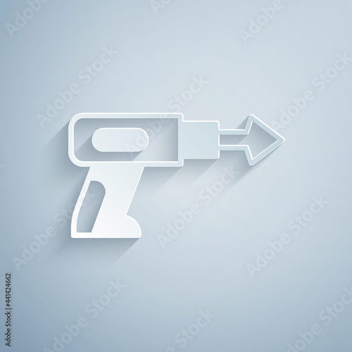 Paper cut Fishing harpoon icon isolated on grey background. Fishery manufacturers for catching fish under water. Diving underwater equipment. Paper art style. Vector