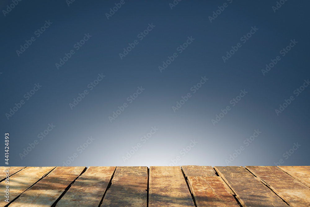 Wooden table on black stage background