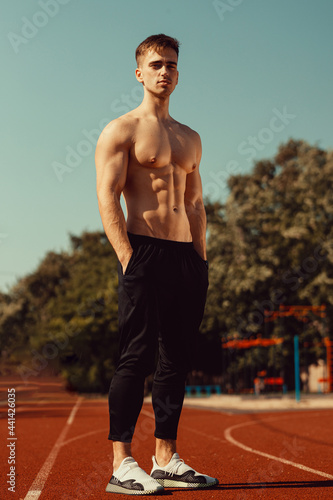 young guy with athletic body getting ready to run