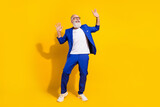 Full length body size photo of man with white beard laughing dancing overjoyed yellow color background