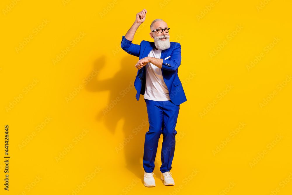 Full length body size view of nice attractive imposing cheerful man dancing having fun isolated over bright yellow color background Full length body size view of nice attractive imposing cheerful man dancing having fun isolated over bright yellow color background