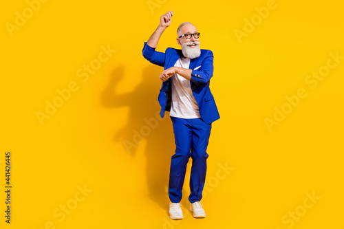Full length body size view of nice attractive imposing cheerful man dancing having fun isolated over bright yellow color background photo