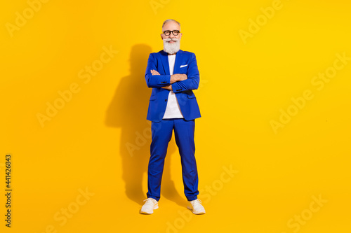 Full length body size view of nice chic classy cheerful man folded arms isolated over bright yellow color background