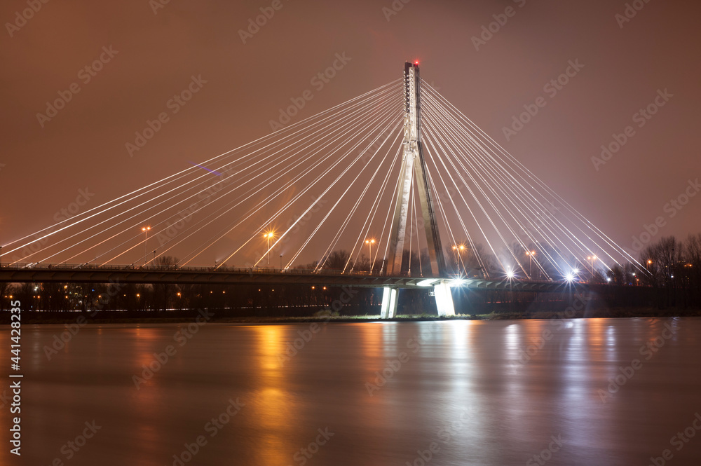 The Świętokrzyski bridge at night against the Vistula river