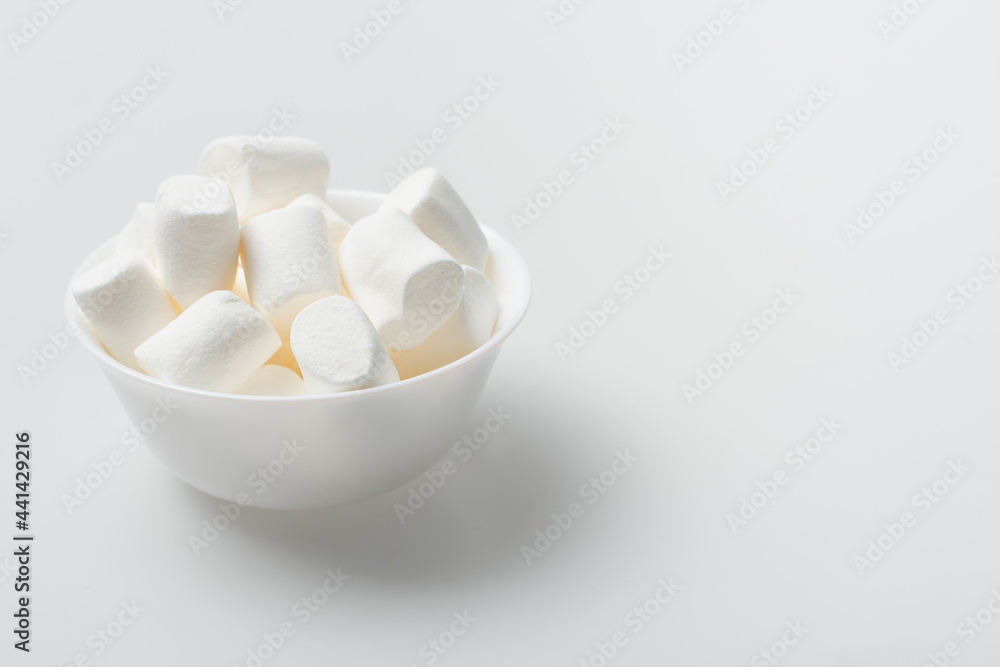 soft and puffy marshmallows in bowl on white soft and puffy marshmallows in bowl on white
