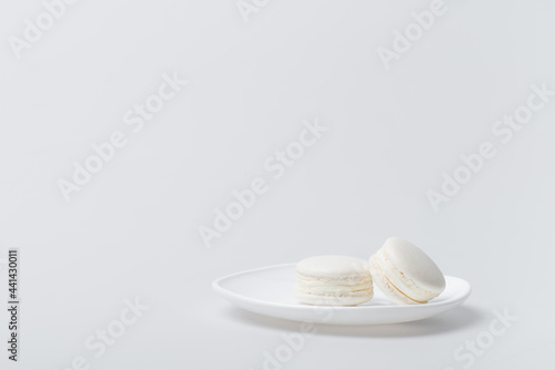 delicious macarons on plate isolated on white