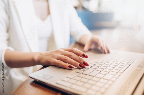 Freelancer Woman hands Using Laptop Computer typing Sitting At Cafe Table. Happy Smiling Girl Working Online Or Studying And Learning While Using Notebook. Freelance Work, Business People Concept