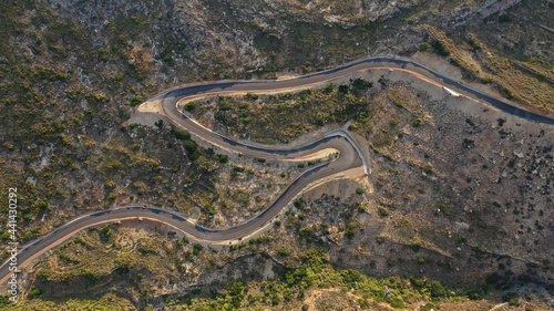 Aerial drone top down photo of serpentine winding asphalt road forming an "S" in uphill Mediterranean destination