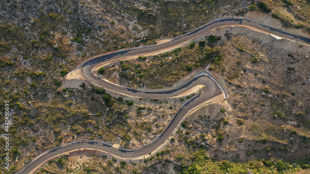 Aerial drone top down photo of serpentine winding asphalt road forming an 
