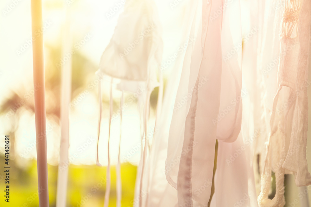 Closeup hanging laundry on balcony on the drying rack at sunset sunshine Closeup hanging laundry on balcony on the drying rack at sunset sunshine