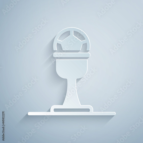 Paper cut Award cup and football ball icon isolated on grey background. Winner trophy symbol. Championship or competition trophy. Paper art style. Vector