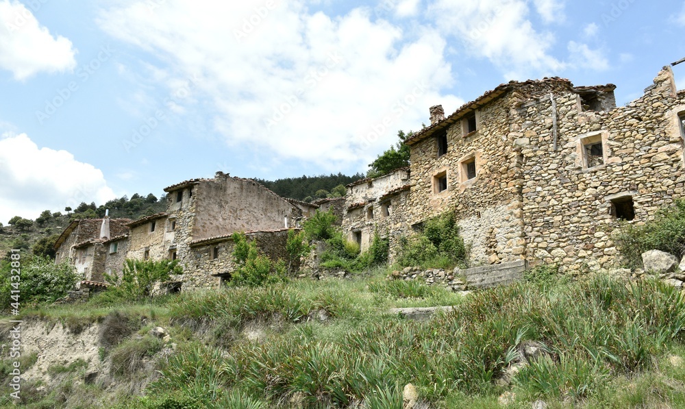 View of the entrance to the village of Armejún, Soria province, Spain. Houses built with dry stone walls in traditional style.