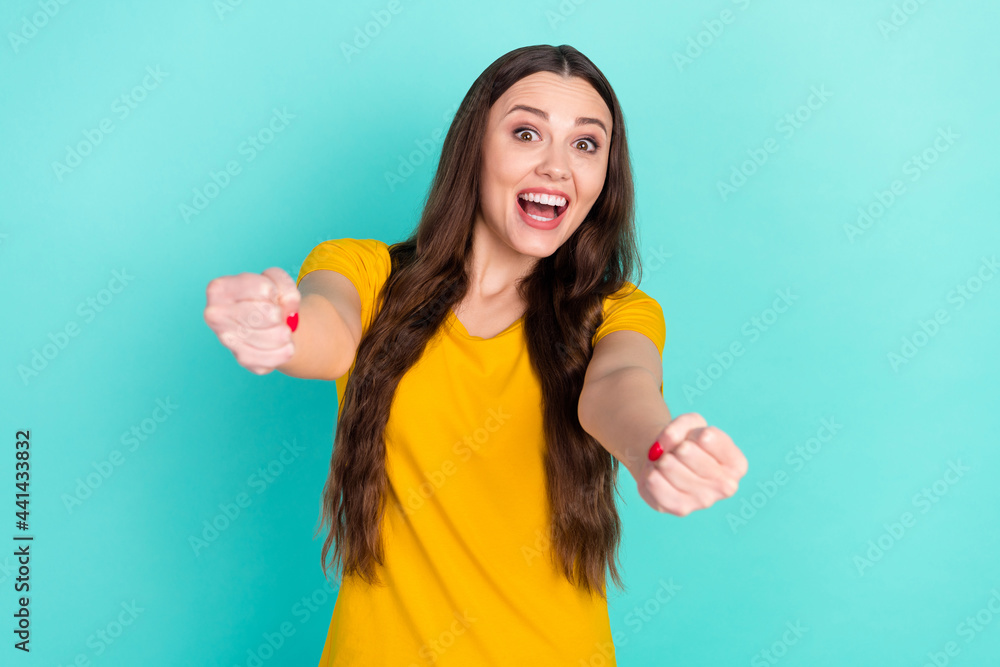 Photo of impressed millennial lady drive car wear yellow t-shirt isolated on vivid teal color background Photo of impressed millennial lady drive car wear yellow t-shirt isolated on vivid teal color background