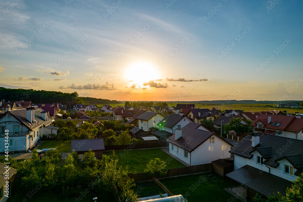 Aerial view of houses in a cottage town at sunset
