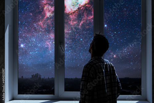 person standing next to the window and watching outside, admire the star on night sky, elements of this image furnished by nasa