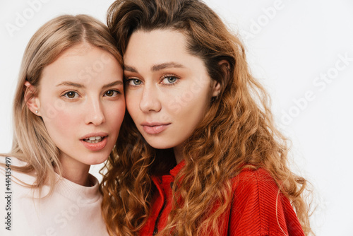 Young european two women posing and looking at camera