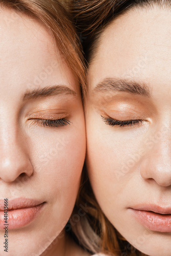 Young european two women posing with their eyes closed