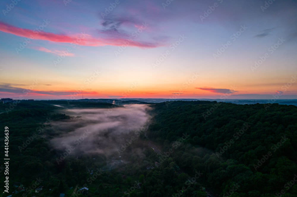 Aerial view of forest and fog at sunset Aerial view of forest and fog at sunset