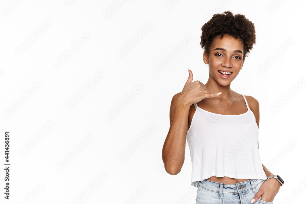 Young black woman in tank top smiling and gesturing at camera Young black woman in tank top smiling and gesturing at camera