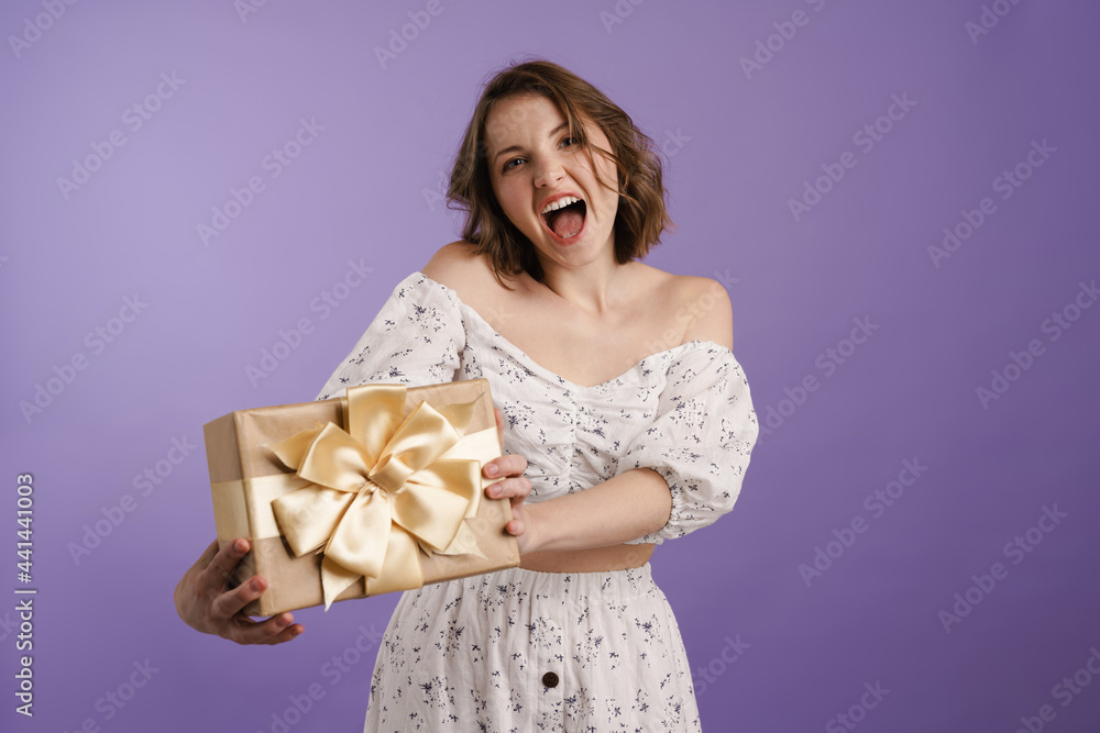 Smiling young white woman holding present box Smiling young white woman holding present box