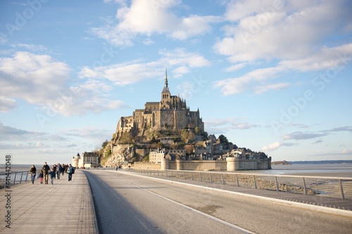 view on the bridge to Mont saint michel with visitors