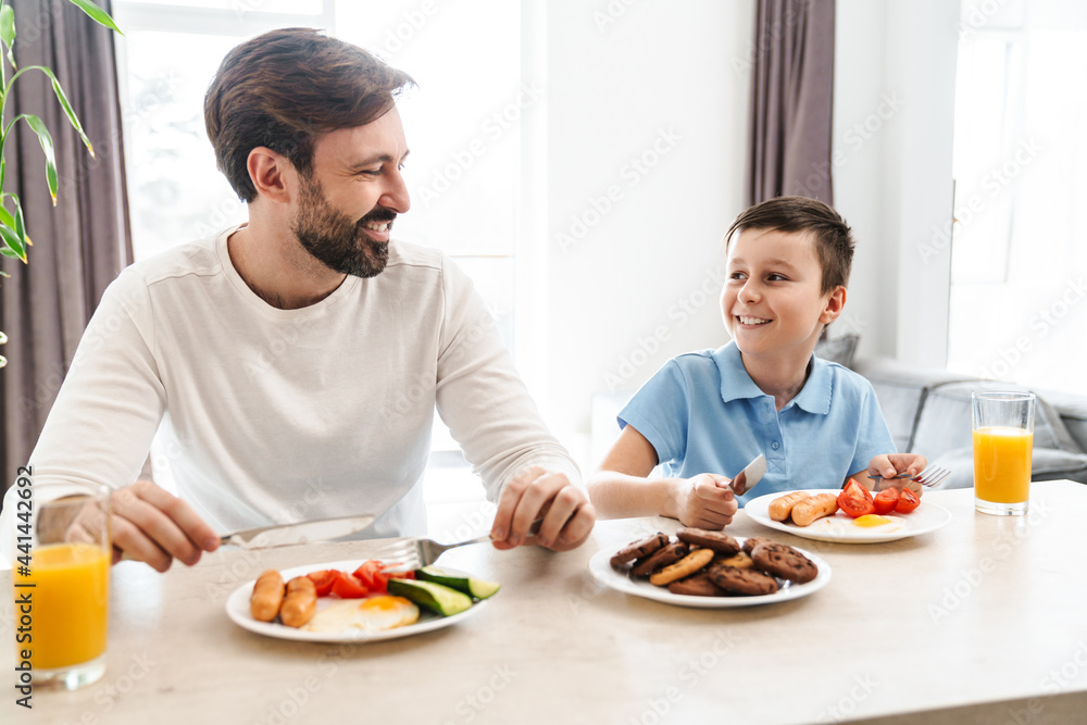 Happy father and his son having breakfast Happy father and his son having breakfast