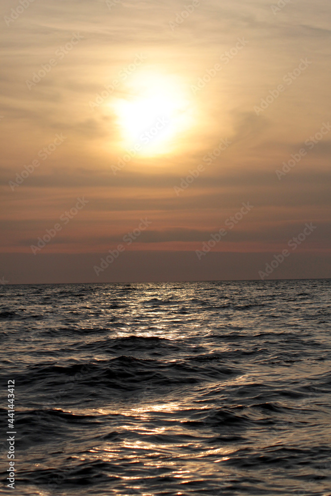 Evening sun over the tropical sea with waves