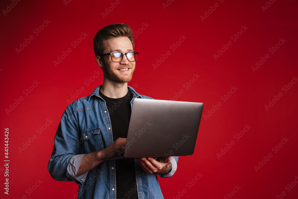 Happy smiling young man in casual clothes standing Happy smiling young man in casual clothes standing