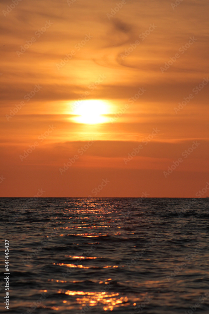 Evening sun over the tropical sea with waves