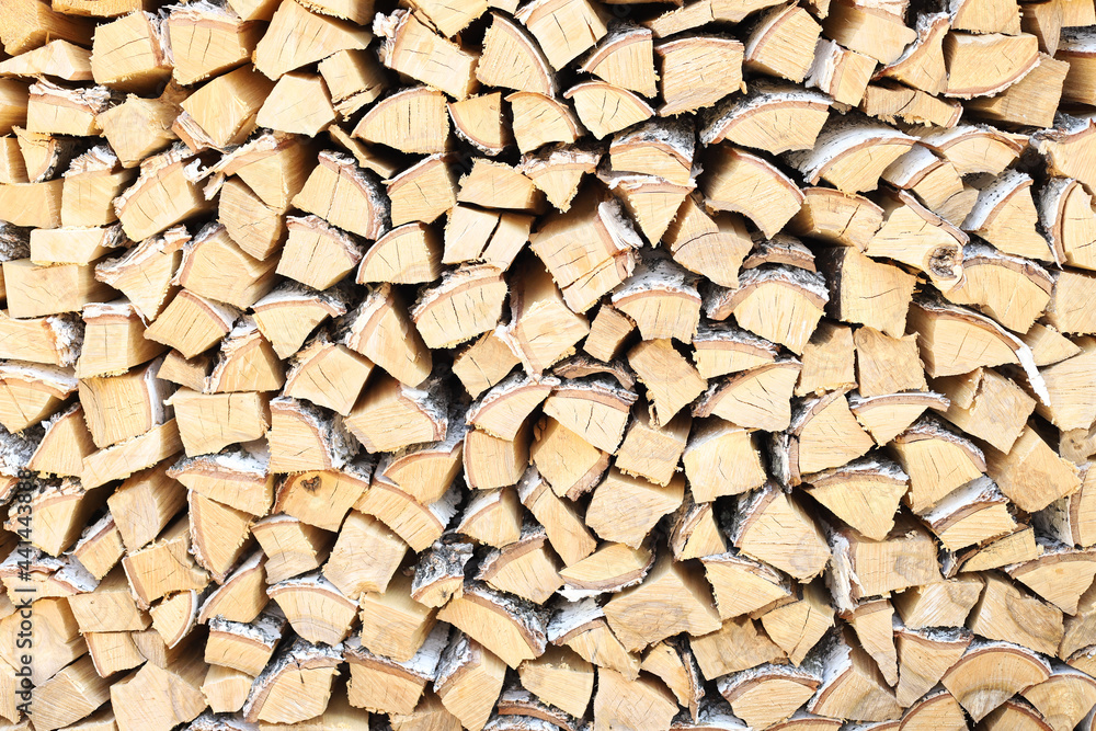 A lot of firewood stacked evenly, texture. Dry birch for furnace. Logs background. Wooden birch logs, bonfire. Closeup, front view. A lot of firewood stacked evenly, texture. Dry birch for furnace. Logs background. Wooden birch logs, bonfire. Closeup, front view.
