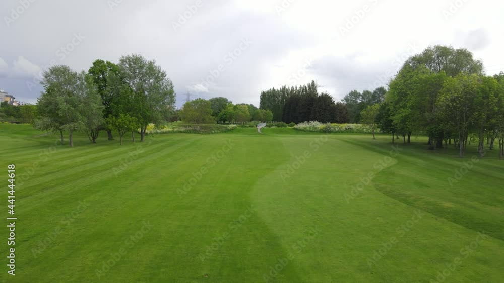 Freshly mowed lawn on golf course and footbridge over channel Freshly mowed lawn on golf course and footbridge over channel
