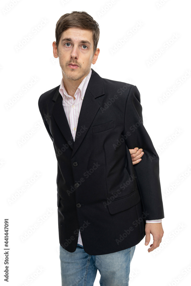 Young handsome tall slim white man with brown hair looks innocent in black blazer in blue jeans isolated on white background Young handsome tall slim white man with brown hair looks innocent in black blazer in blue jeans isolated on white background