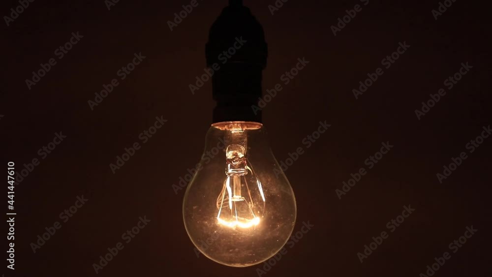 Light bulb on black background. dark to light on the room footage clip. close-up Light bulb on black background. dark to light on the room footage clip. close-up