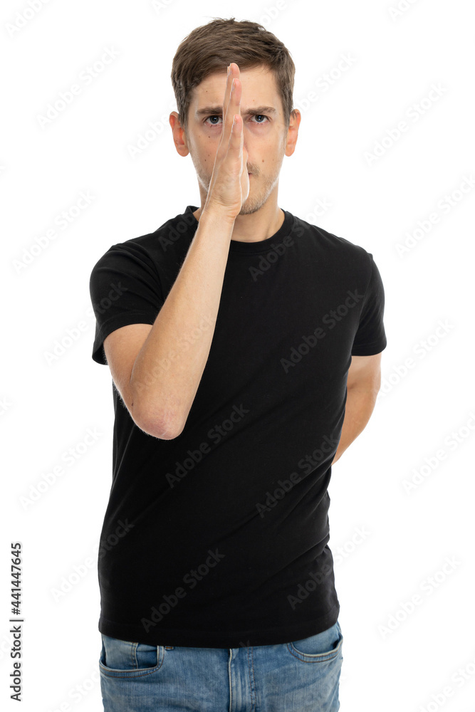 Young handsome tall slim white man with brown hair with his hand splitting his face in black shirt isolated on white background Young handsome tall slim white man with brown hair with his hand splitting his face in black shirt isolated on white background