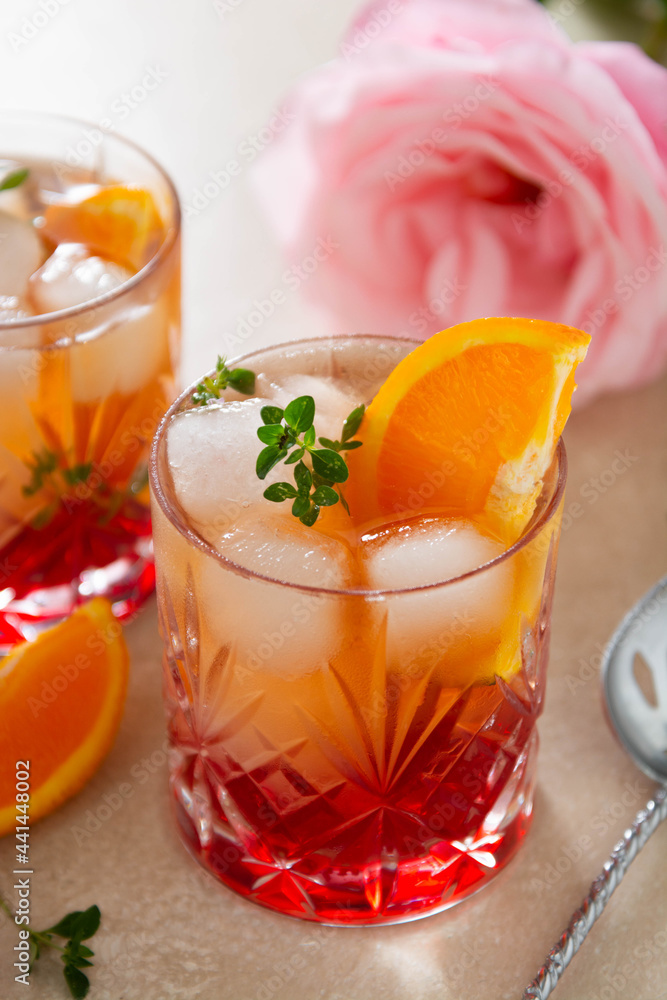 Summer cocktail with strawberries, oranges and fresh herb, delicious homemade lemonade with syrop Summer cocktail with strawberries, oranges and fresh herb, delicious homemade lemonade with syrop