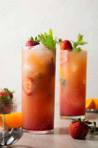 Pink lemonade with fresh strawberries  orange fruit and mint. Fresh summer fruit cocktails.