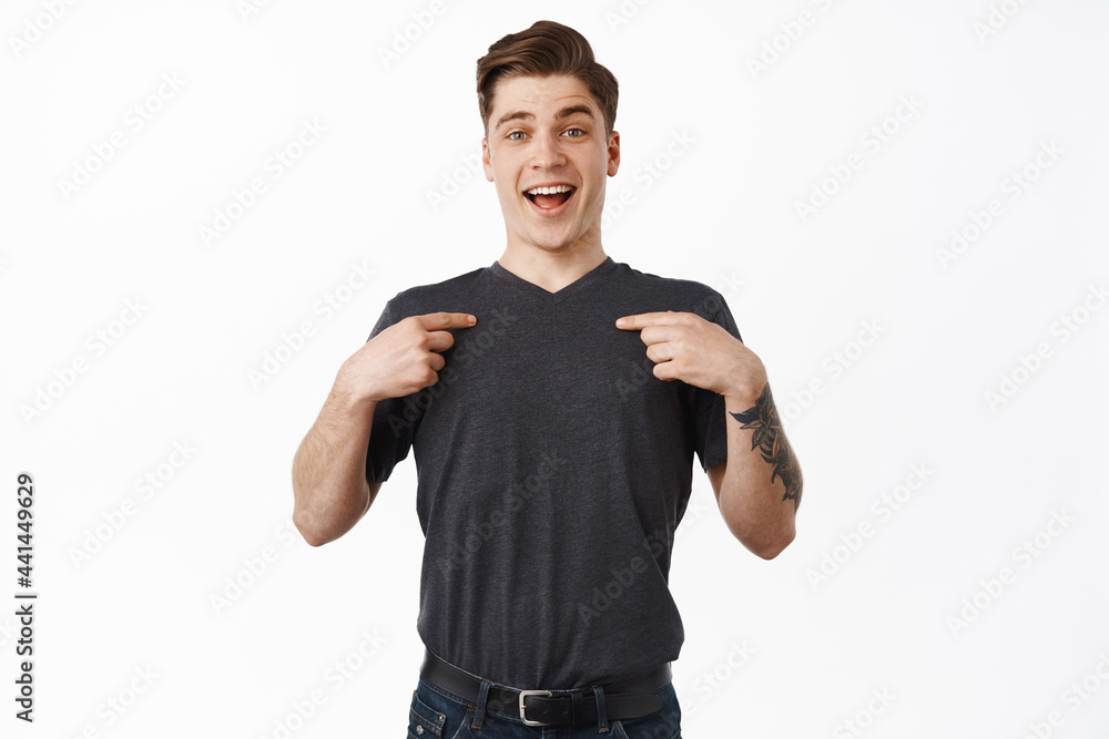 Happy hopeful man pointing at himself, smiling and looking excited, asking to take part in event, volunteering, self-promoting and bragging, white background Happy hopeful man pointing at himself, smiling and looking excited, asking to take part in event, volunteering, self-promoting and bragging, white background