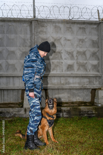 Female police officers with a trained dog. German shepherd police dog.