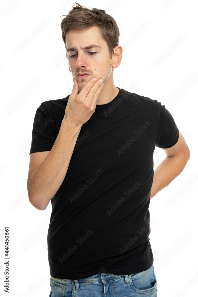 Young handsome tall slim white man with brown hair is making a decision in black shirt in blue jeans isolated on white background Young handsome tall slim white man with brown hair is making a decision in black shirt in blue jeans isolated on white background
