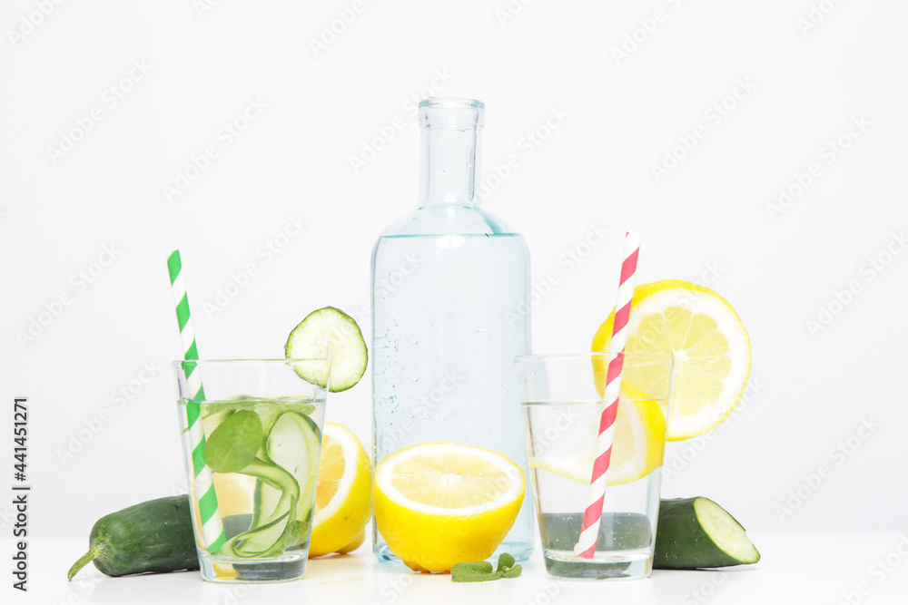 Lemon cucumber water with colorful paper straw. Healthy detox drink. Lemon cucumber water with colorful paper straw. Healthy detox drink.