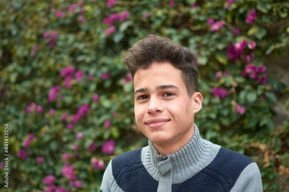 A portrait of a happy Hispanic male in the park A portrait of a happy Hispanic male in the park
