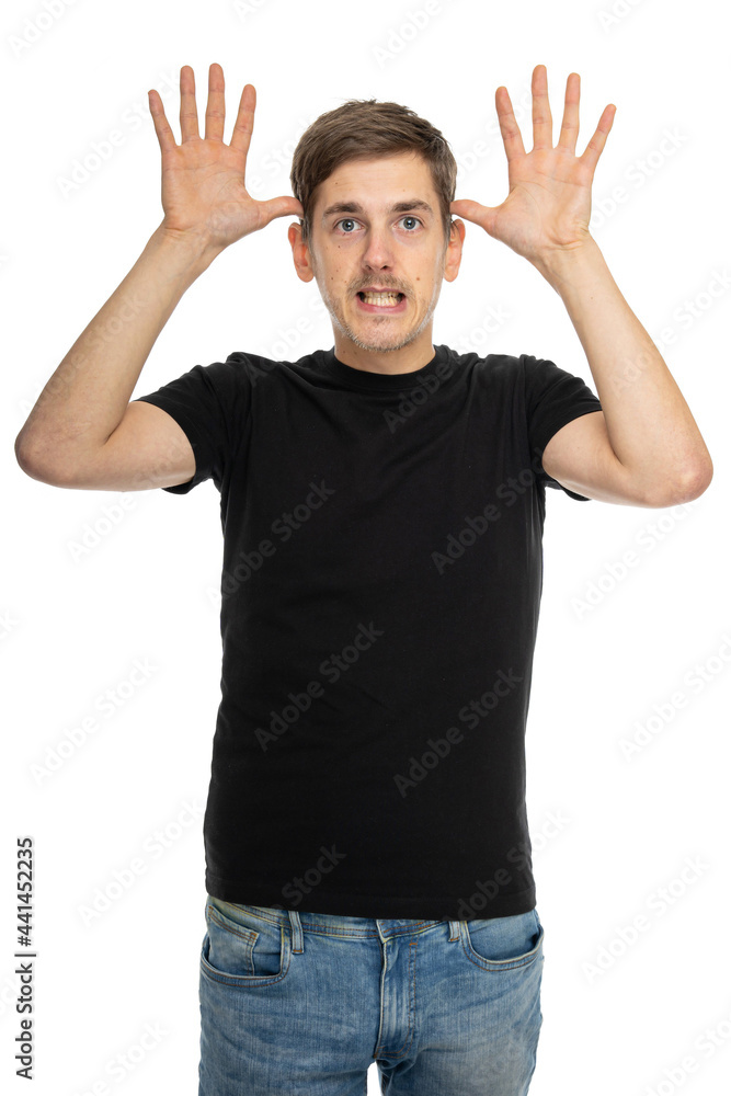 Young handsome tall slim white man with brown hair doing antlers gesture in black shirt in blue jeans isolated on white background Young handsome tall slim white man with brown hair doing antlers gesture in black shirt in blue jeans isolated on white background