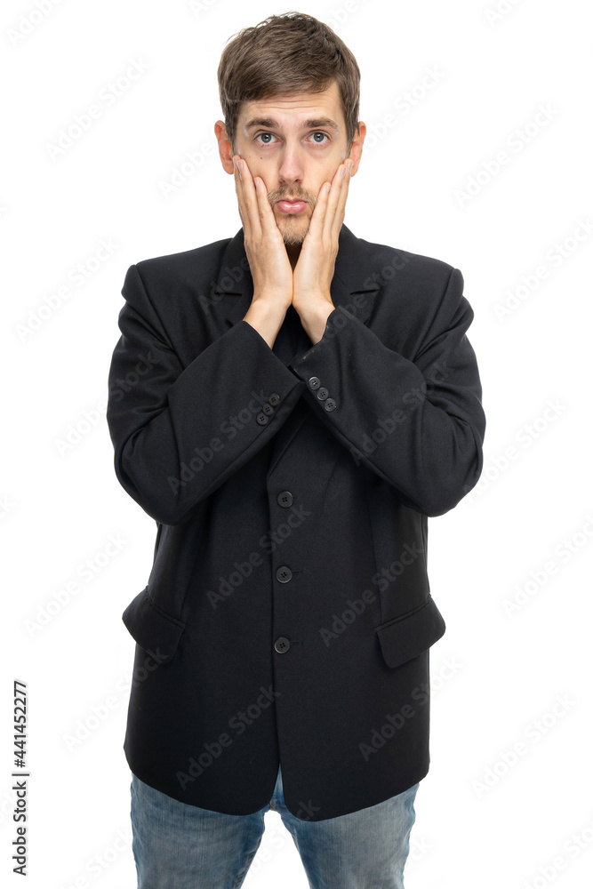 Young handsome tall slim white man with brown hair looks sad in black blazer in blue jeans isolated on white background Young handsome tall slim white man with brown hair looks sad in black blazer in blue jeans isolated on white background