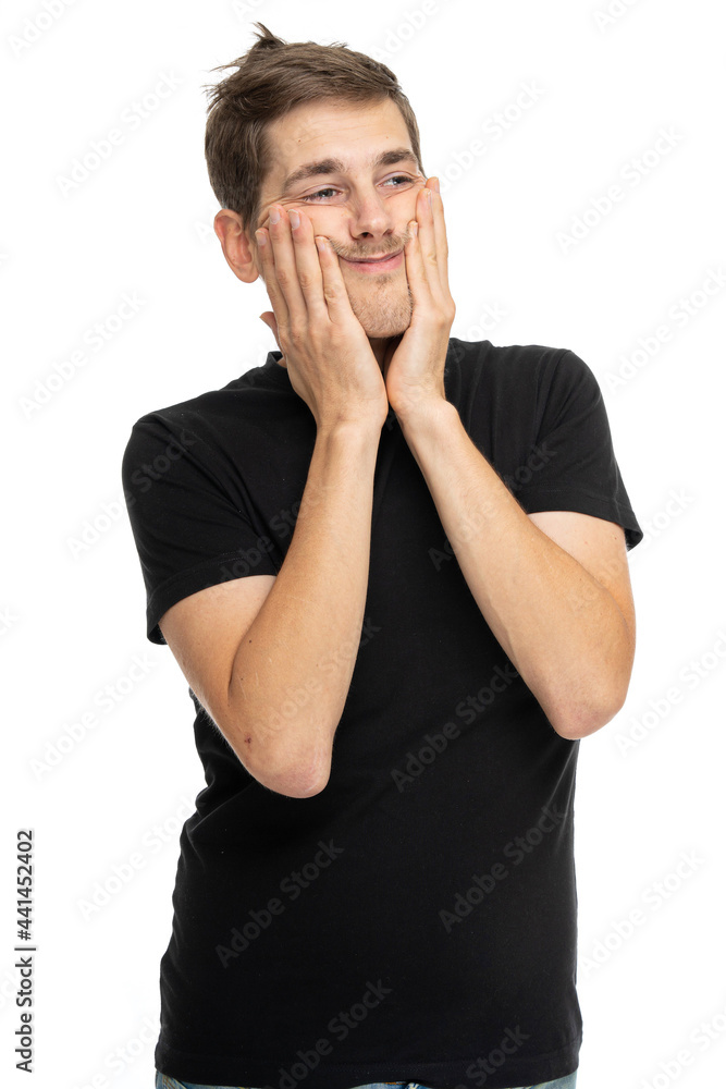 Young handsome tall slim white man with brown hair touching his cheeks with a little smile in black shirt isolated on white background Young handsome tall slim white man with brown hair touching his cheeks with a little smile in black shirt isolated on white background