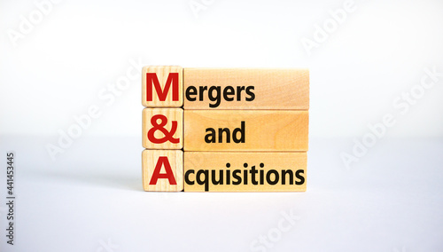 Mergers and acquisitions symbol. Concept words 'M and A, Mergers and acquisitions' on wooden blocks on a beautiful white background. Business and Mergers and acquisitions concept. photo