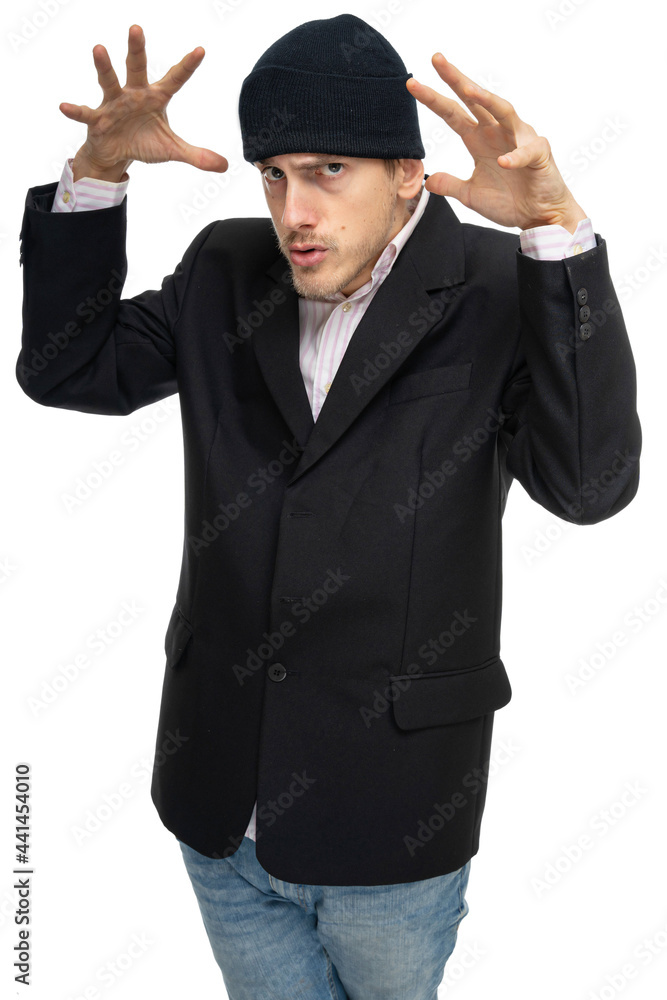 Young handsome tall slim white man with brown hair looks angry in black blazer with black winter hat isolated on white background Young handsome tall slim white man with brown hair looks angry in black blazer with black winter hat isolated on white background