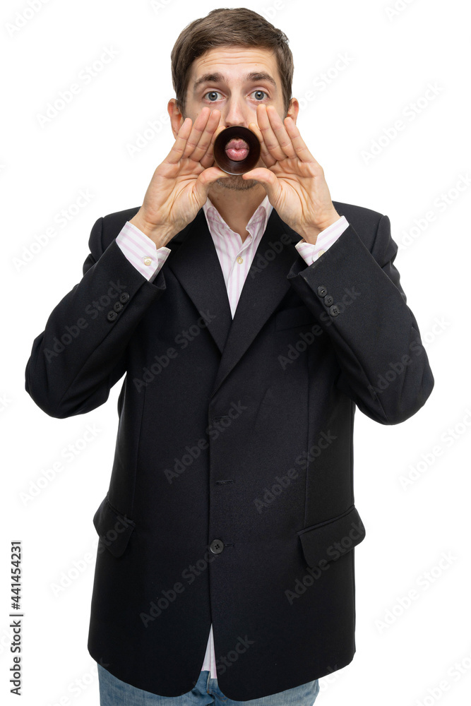 Young handsome tall slim white man with brown hair with wooden ring on his mouth in black blazer isolated on white background Young handsome tall slim white man with brown hair with wooden ring on his mouth in black blazer isolated on white background