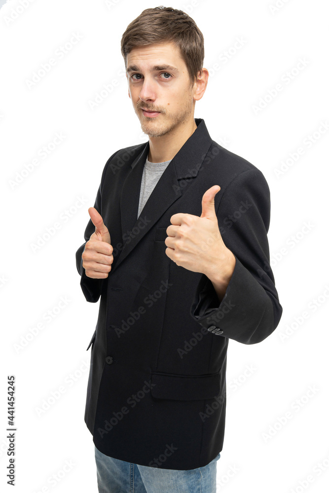 Young handsome tall slim white man with brown hair showing thumbs up in black blazer in blue jeans isolated on white background Young handsome tall slim white man with brown hair showing thumbs up in black blazer in blue jeans isolated on white background