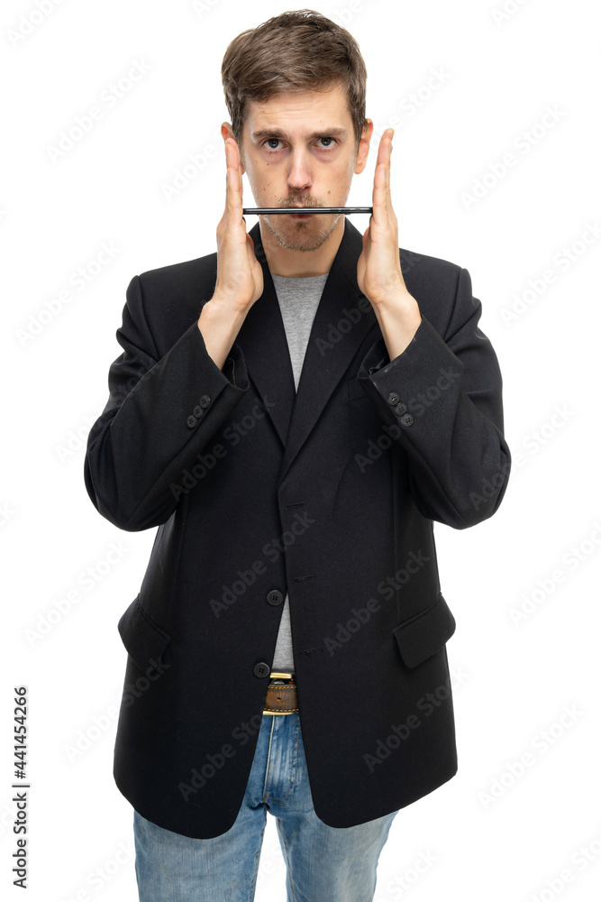 Young handsome tall slim white man with brown hair holding his mobile phone flat in black blazer in blue jeans isolated on white background Young handsome tall slim white man with brown hair holding his mobile phone flat in black blazer in blue jeans isolated on white background